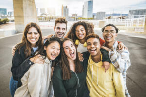 Multiracial group of friends taking selfie picture outdoors - Millennial people having fun on city street - International students smiling together at camera - Youth culture and community concept