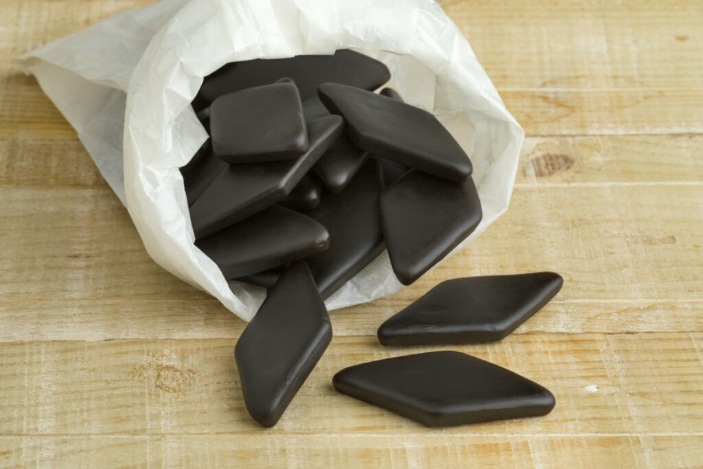 Paper sack with black salt licorice confection, a Dutch candy called drop