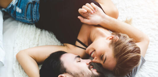 Passionate woman gently kissing man on with romantic kiss.desire lying on bed, young tender lover enjoys touching soft skin of sensual sexy lady moaning having sex.