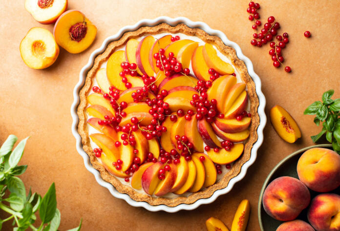 Peach and red currant tart with ricotta cheese, overhead view of homemade freshly baked pastry ready to eat