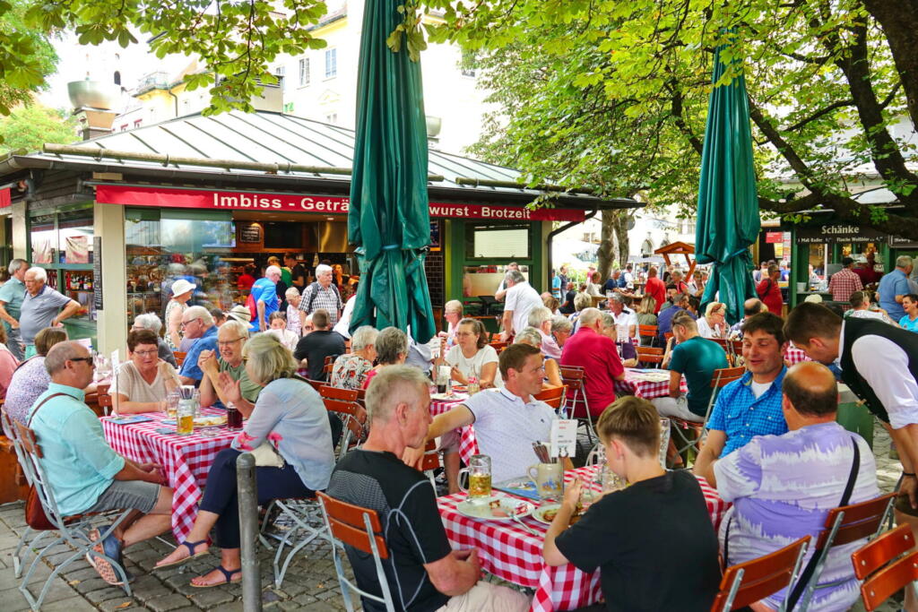 People at the Munich Viktualienmarkt. Munich's most famous permanent food market. Munich, GERMANY - August 2022