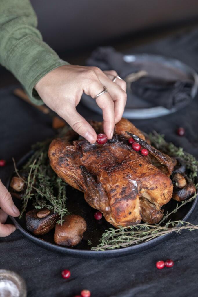 Person holding a roasted turkey