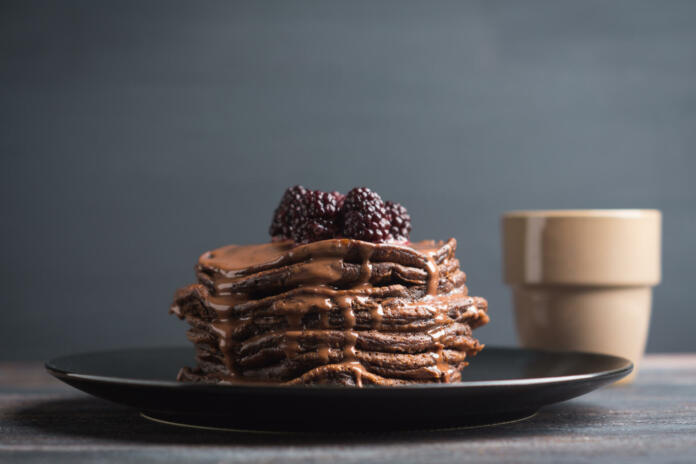 Stack of pancakes with fresh blackberries. Shallow depth of field.