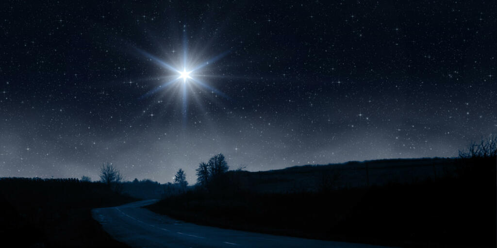 Bright star shines over the road at night. Birth of Jesus concept, Star of Bethlehem