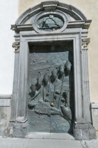 Bronze sculpture of bishops by Marko Mitic on a door on the Cathedral of St. Nicholas in Ljubljana in Slovenia