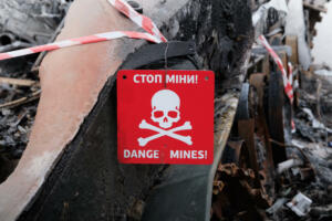 Danger mines sign on a blown up tank in Bucha