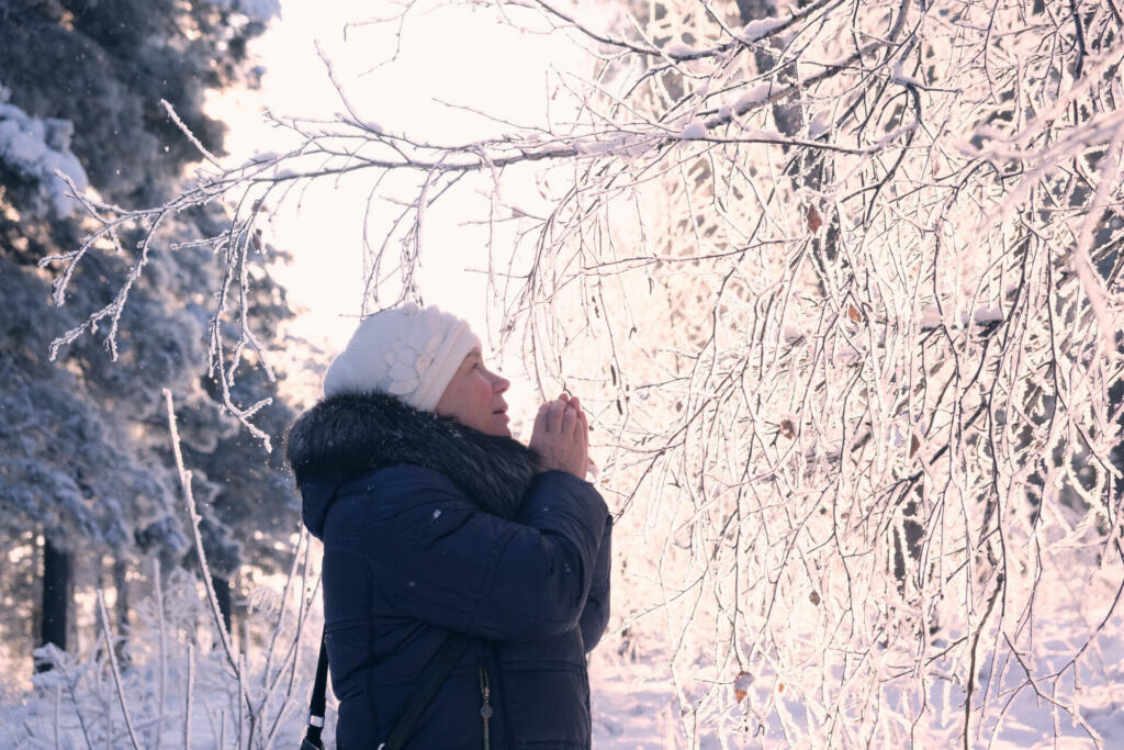 Senior woman enjoying a winter day in the nordic forest