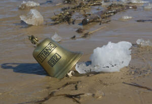 Ship bell of Titanic ship in sand