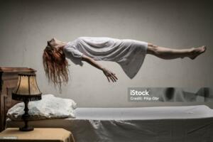 Woman levitating over bed / astral traveling, nightmare, excorcist halloween concept