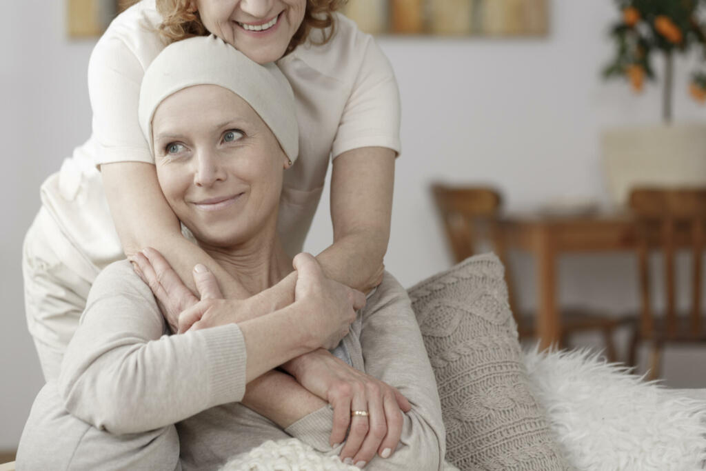 Family member supporting sick woman during chemotherapy