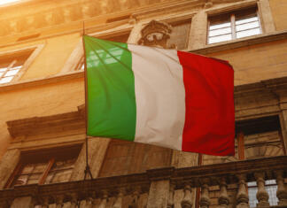 Razklana Italija: Sever proti jugu Italian flag on the streets of the old town. Bottom view