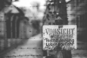 Poland, Auschwitz - April 18, 2014: Warning sign in the former concentration and extermination camp Auschwitz