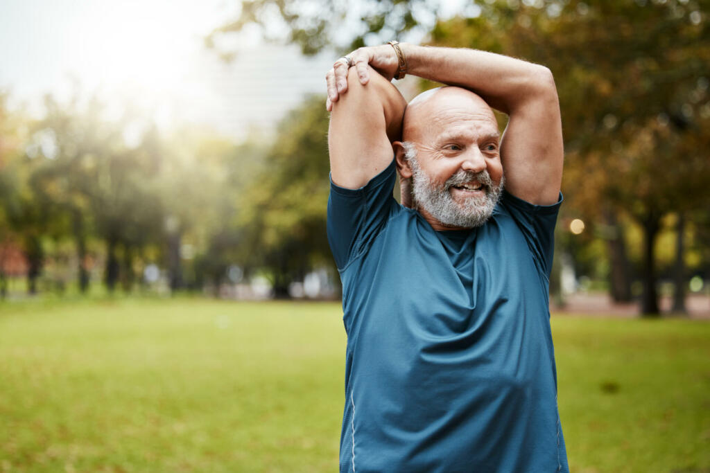 Stretching, fitness and running with old man in park for health, workout or sports with mockup. Warm up, retirement and exercise with senior runner in nature for training, jogger and cardio endurance