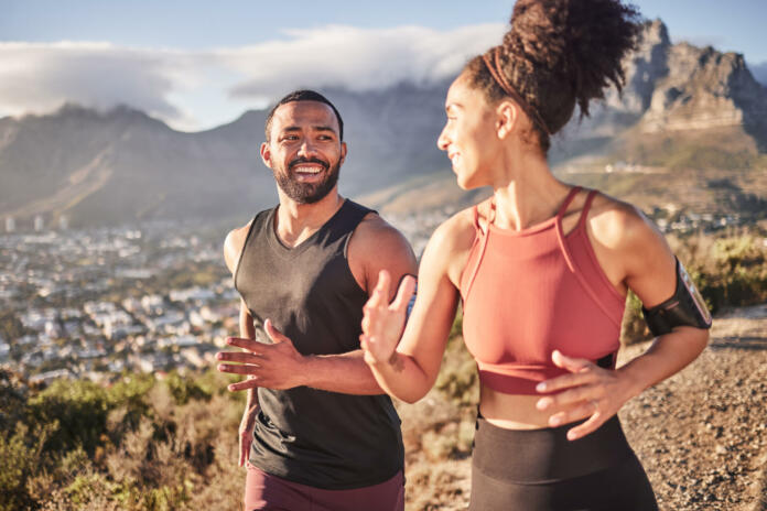 Training, exercise and black couple running in nature for fitness, heart health and wellness. Sports, cardio and happy man and woman jog or runner workout outdoors preparing for marathon together.