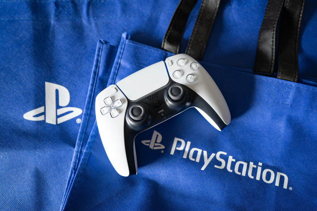 Bangkok, Thailand - December 27, 2022: Playstation 5's DualSense game controller and Playstation logo.