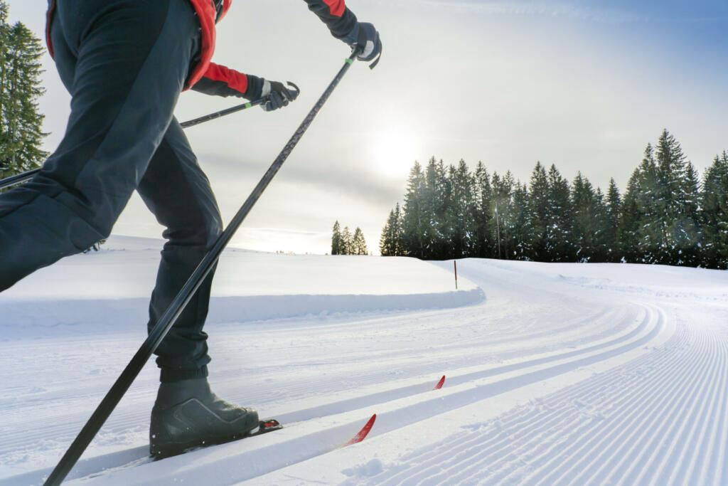 beautiful active senior woman cross-country skiing in fresh fallen powder snow in the Allgau alps near Immenstadt, Bavaria, Germany