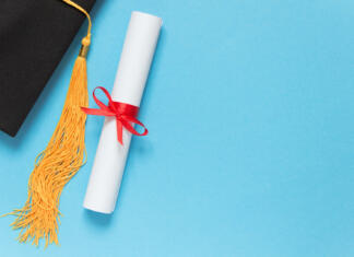 Nasveti za najboljšo diplomsko nalogo Graduation top view concept. Academical hat and diploma on blue background. Copy space