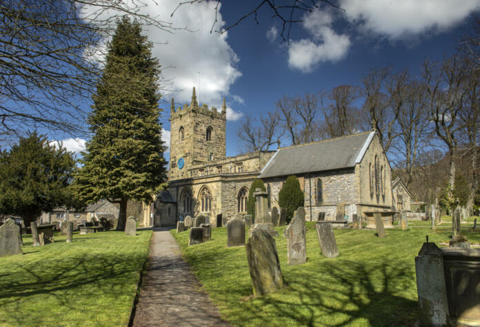 landscape view of the church in the village of Eyam where villagers chose to isolate themselves after the plague arrived in 1665