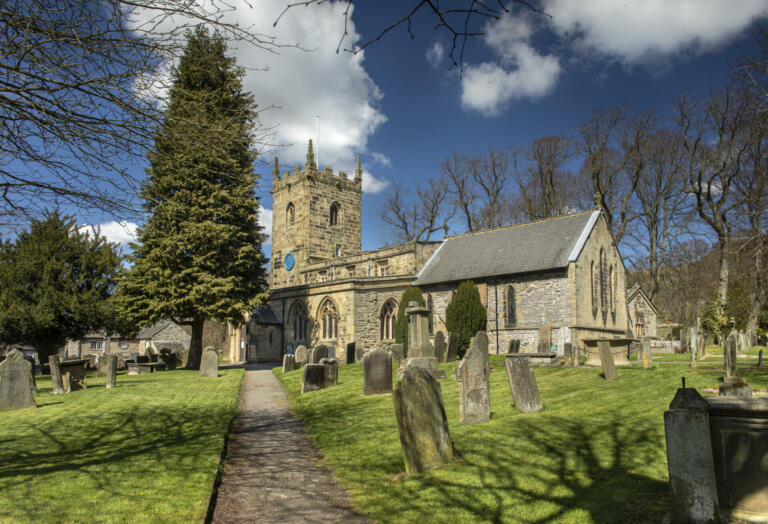 landscape view of the church in the village of Eyam where villagers chose to isolate themselves after the plague arrived in 1665