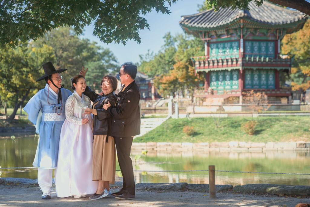 Seoul, South Korea – October 12, 2022: A joyful family in traditional Korean dresses at the Gyeongbokgung Palace in Seoul, South Korea
