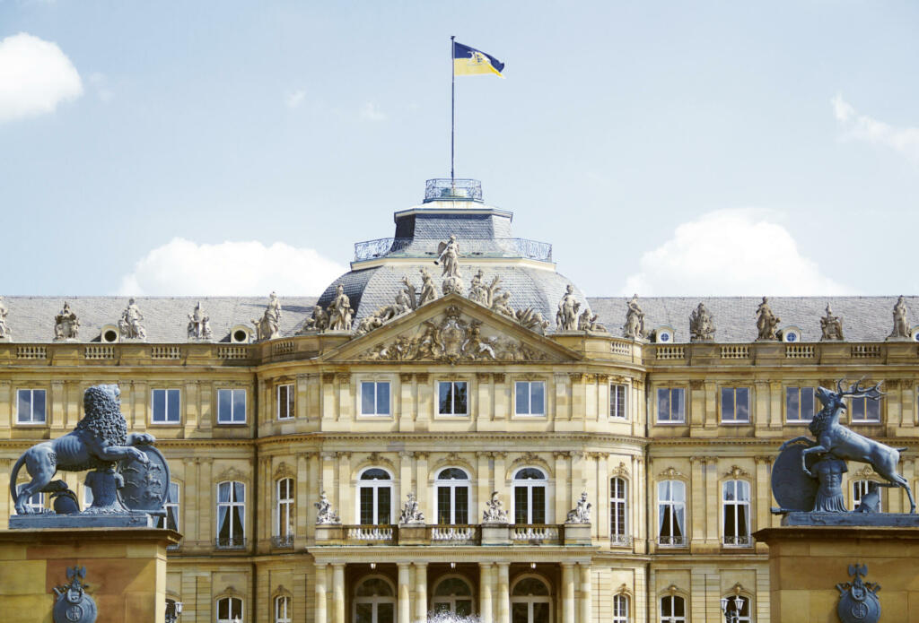 Stuttgart, Baden-Wuerttemberg, Germany - Aug 14, 2021 - New Palace Main Facade with Deer and Lion Heraldic Animal Statues, View from New Palace Ornamental Garden Palace Square, Traditional National Symbols of Baden-Wuerttemberg and Historic Swabia (Residence of the Dukes and Kings of Württemberg), Western Europe, European Union