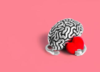 Znanost dokazuje! Ljubezen vpliva na možgane Valentine's Day card mockup: Steel brain holding a red heart on pink. Robust intellect and the delicate beauty of love.