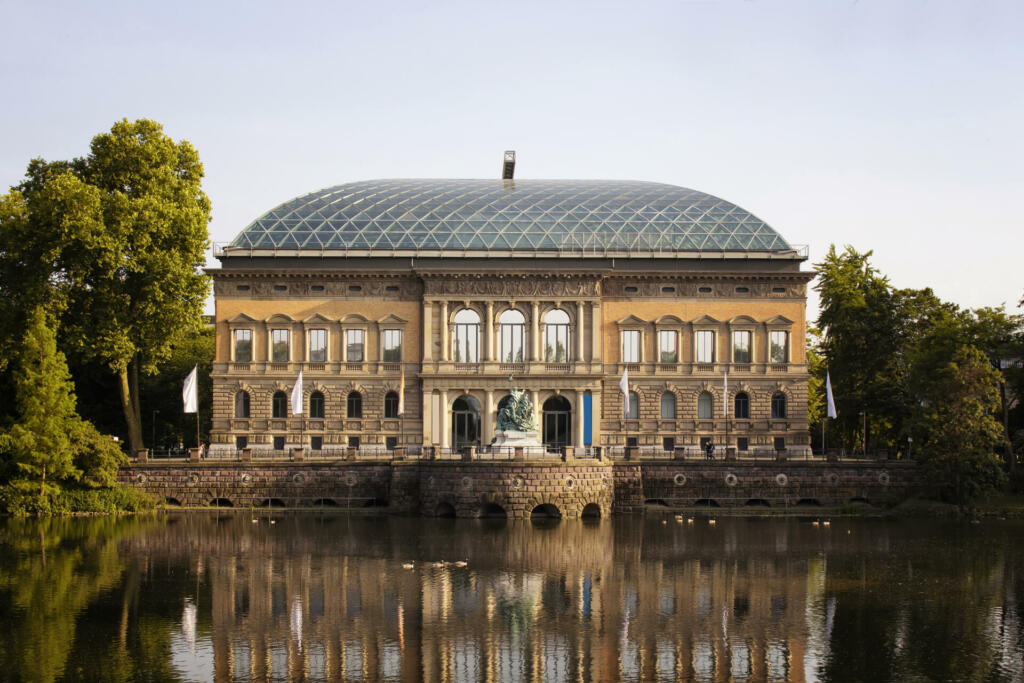 View of a modern art museum (K21, Kunstsammlung Nordrhein-Westfalen) in Dusseldorf. Lake and trees is also in view.