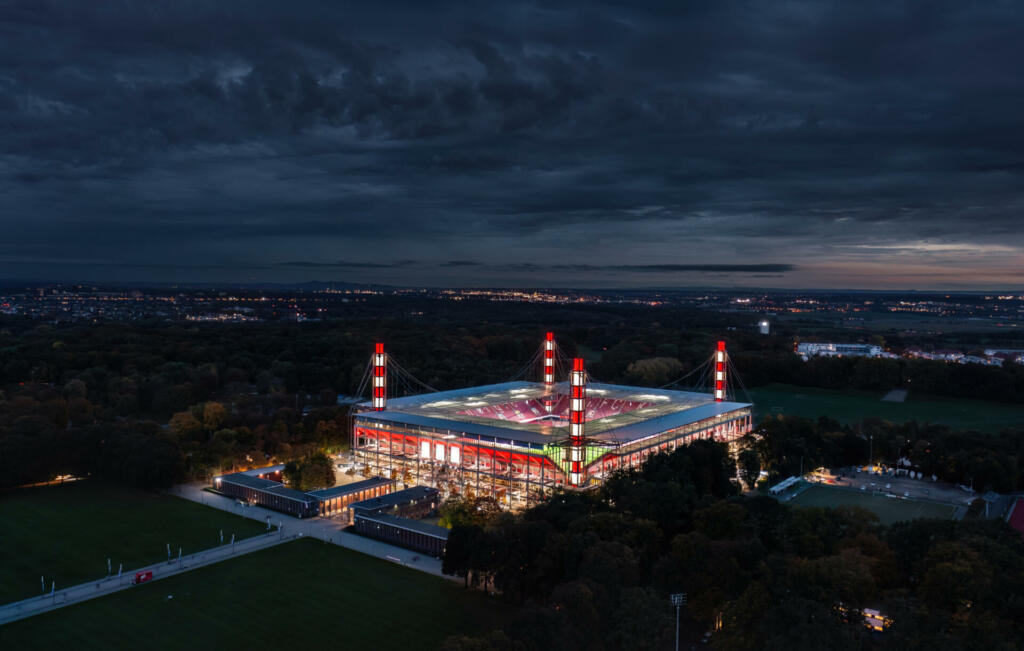 Cologne, Germany - October 2022: Night aerial view of the illuminated RheinEnergieStadion (Müngersdorfer Stadion), home stadium for football club 1. FC Köln