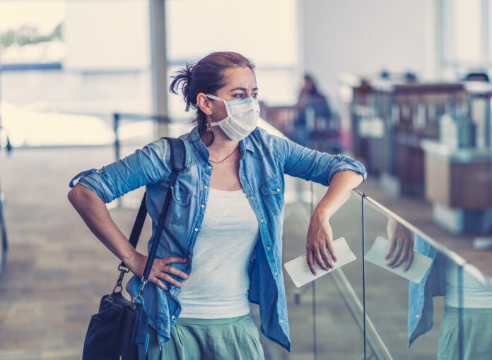 COVID-19 worldwide borders closures.Traveler with face mask stuck in airport terminal after being denied entry to other countries. Passenger stranded in airport on his travel back to home country.