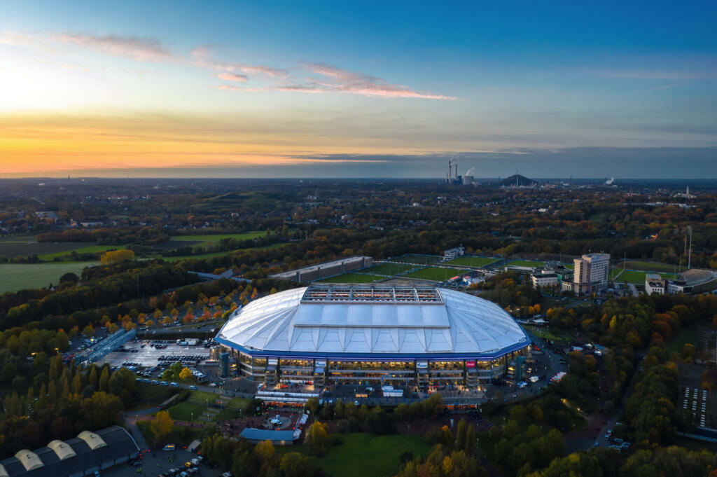 Gelsenkirchen, North Rhine-Westphalia, Germany - October 2021: Arial panoramic view on Veltins Arena (also known as Arena AufSchalke) at sunset, home stadium for Bundesliga team FC Schalke 04