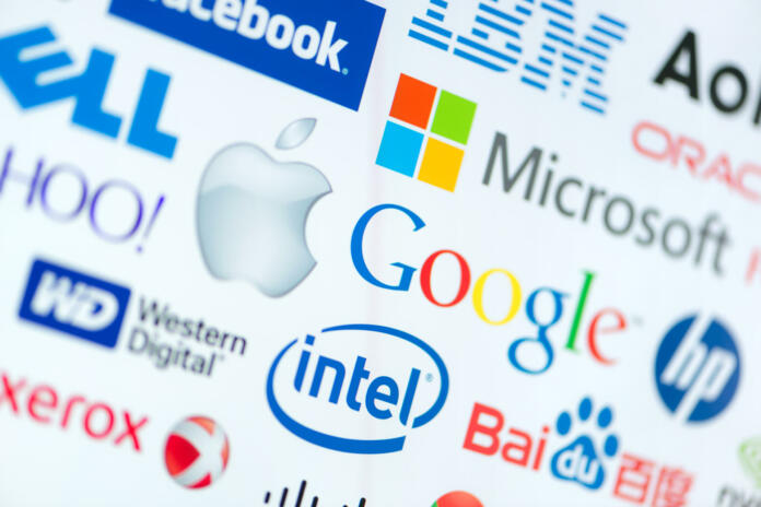 Kiev, Ukraine - June 12, 2014: A logotype collection of well-known world top companies of computer technologies on a monitor screen. Include Google, Apple, Microsoft, Intel and other logos.