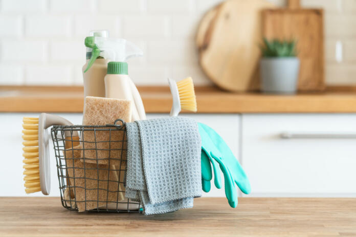 Modern kitchen interior in the background. House cleaning concept