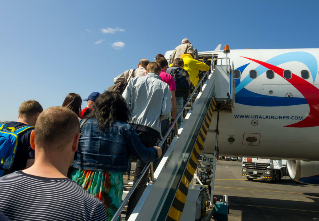 Moscow, Russia - June 1, 2016: Passengers climb the ladder on the plane of airline "Ural Airlines" in Domodedovo airport