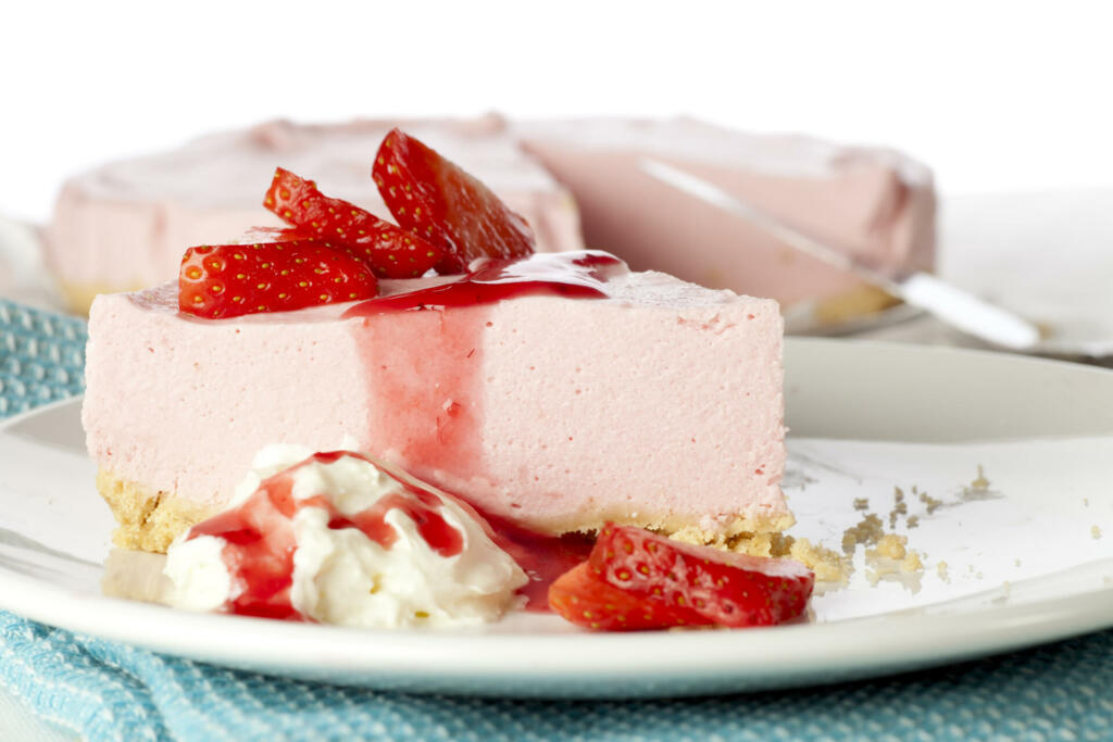 Strawberry mousse with gram cracker crust, whipped cream and fresh strawberries