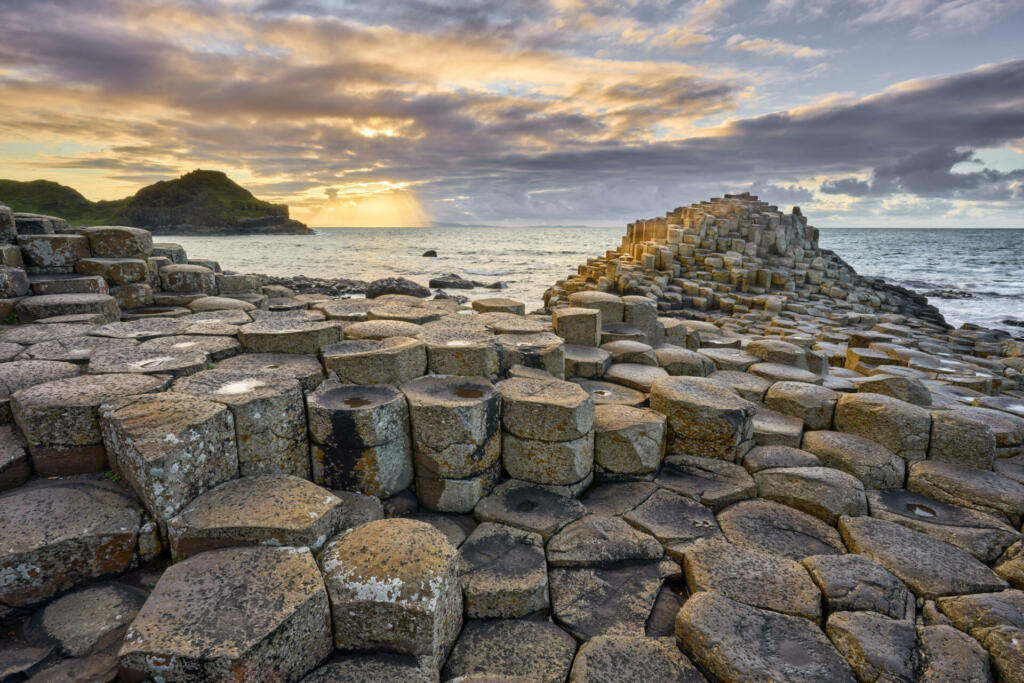 atlantic coastline with Volcanic hexagonal basalt columns of Giant`s Causeway at sunset in Northern Ireland