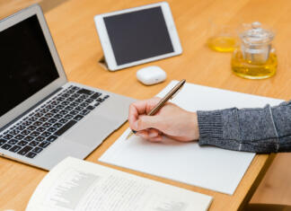 Pomoč pri urejanju diplomske naloge je na dosegu roke! Hands of men studying using a laptop and tablet PC