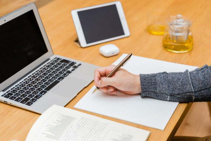 Hands of men studying using a laptop and tablet PC