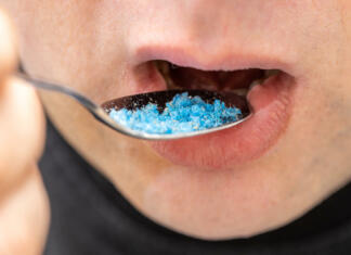 Tako mikroplastika vpliva na naše telo: Ugotovitve so daleč od prijetnih Microplastic in food, Environment and health concept, Person putting a spoon with plastic particles in his mouth