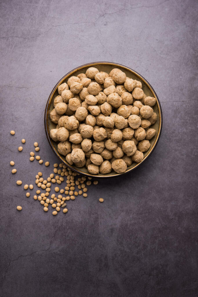 Raw Soya Chunks, Soy Meat for vegans isolated on colourful background in a bowl or in heap form