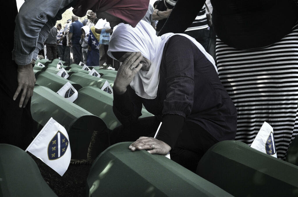 Since 2005, in July, people from all over the world have been arriving in Bosnia and Herzegovina to attend the funeral ceremony held for the victims of the genocide at the Potočari Memorial.Four hundred Dutch UN soldiers had the task of defending the territory of Srebrenica, declared an area under international protection. But it didn't happen. When Serbian troops on 11 July 1995 occupied Srebrenica under the command of General Mladic, UN soldiers retreated here to their base in Potocari and did not defend the city. The UN commands did not make the fighters intervene to stop the Serbs thus allowing the massacre. The coffins are covered with green canvas, inside there are the few remains of the killed person. A tag with a number remembers its name. Family members and relatives look for their loved one's coffin. They caress her, someone sits next to them and stays there for hours.