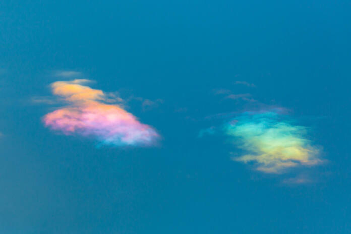 two natural clouds with natural circumhorizontal arc in blue sky