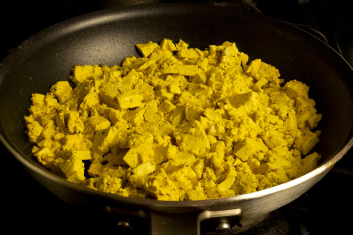 Vegan eggs in fry pan on gas stove