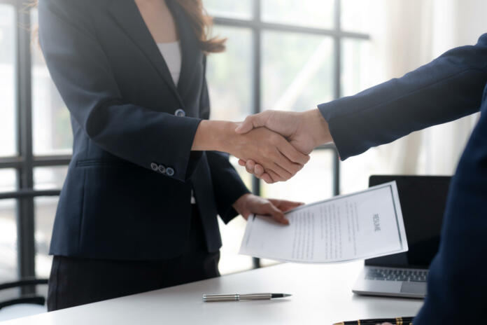 Employment and recruitment. Human resources manager shaking hands with job applicants. Greeting and welcoming new employees.