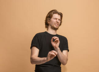 Koga ali česa ne maraš? Rodilnika! Ew. It's so gross. Young man with disgusted expression repulsing something. Disgust concept. Young emotional man. Human emotions, facial expression concept. Studio. Isolated on trendy pastel color