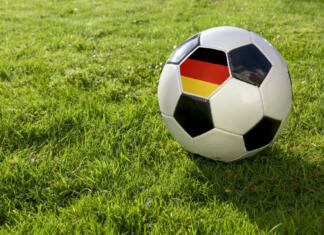 Kje dobiti vstopnice za EURO 2024? Football on a grass pitch with German Flag