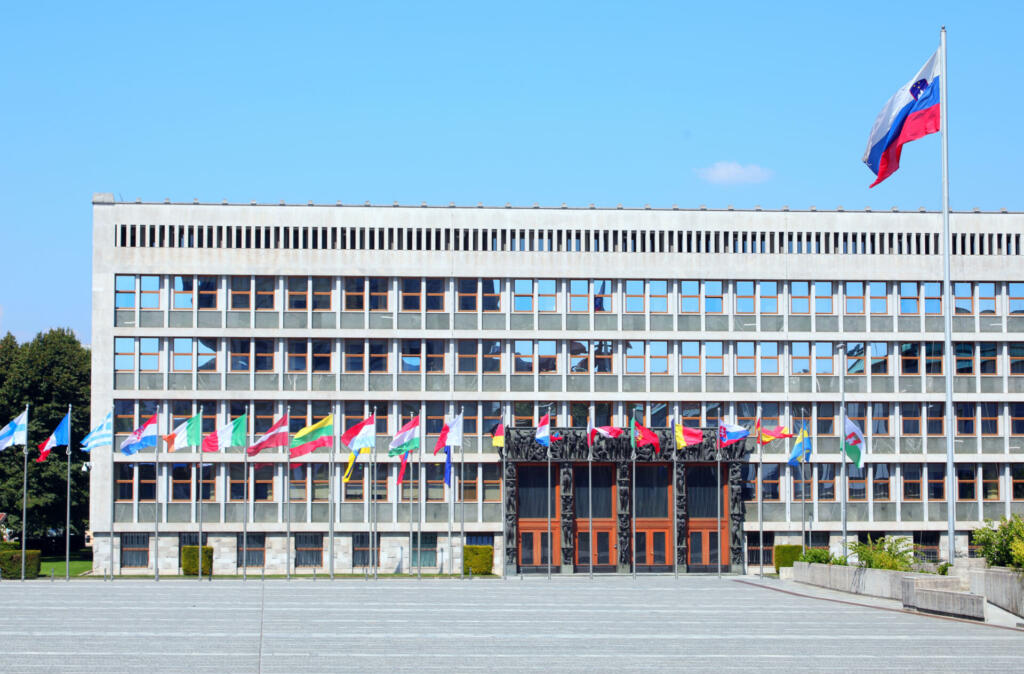 Ljubljana, L, Slovenia - August 16, 2023: Parliament building of the European Capital and many flags