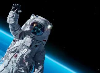 Pri 90. letih končno postal astronavt, potem, ko mu je to onemogočila politika 12 April 1969, International day of human space flight, Cosmonautics Day concept with ISS astronaut in spacesuit against background of the Earth planet. Spaceman in outer space 3D science illustration