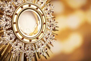 Monstrance on yellow bokeh background.