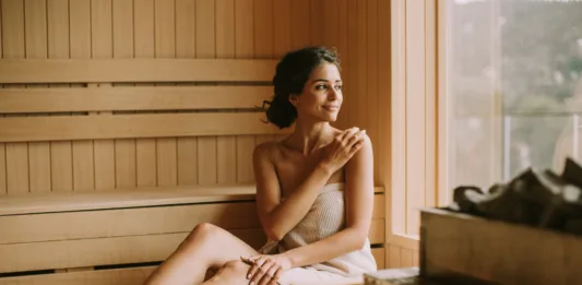 Attractive young woman relaxing in the sauna