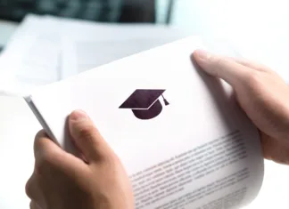 Vas zanima poklic kozmetičarke ali fizioterapevta? Vpisi potekajo celo leto College or university application or letter from school. Student or teacher reading education document. Young man holding grant, graduation, study loan or scholarship paper.